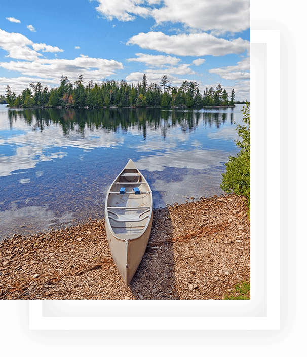 A canoe on the shore of a lake.